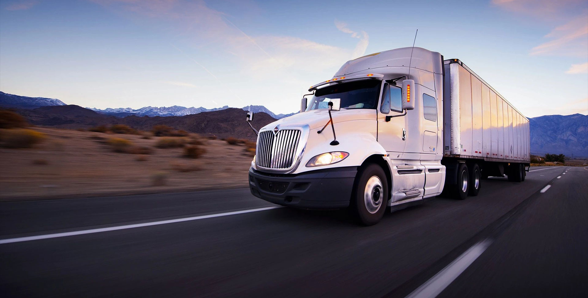 Truck and highway at sunset - transportation background